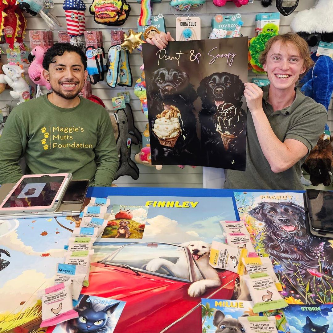 Two artists at ani-mal's design showcasing their pet artwork at a pet supply store